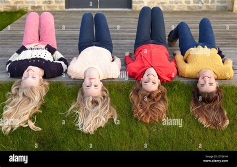 Four Teenage Girls Lying On Patio And Looking Back Stock Photo Alamy