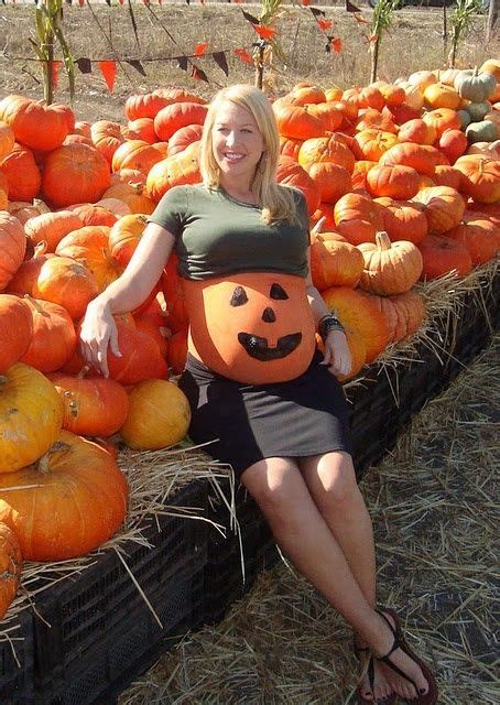 Pregnant With A Pumpkin Painted Belly At A Pumpkin Patch Pregnant