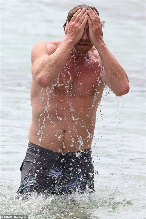 Simon Baker Shows Off His Sculpted Physique At The Beach With A Female