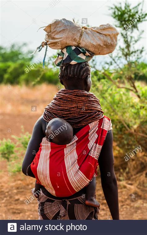 African Woman Carrying Baby On Back Stock Photos And African Woman