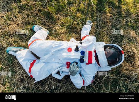 Female Astronaut Lying On Land In Forest Stock Photo Alamy