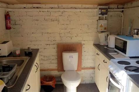 Bog Standard Kitchen Pictured With Toilet Fitted Between Cooker And