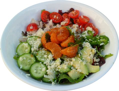 A White Bowl Filled With Lots Of Different Types Of Vegetables On Top Of Rice And Cucumbers