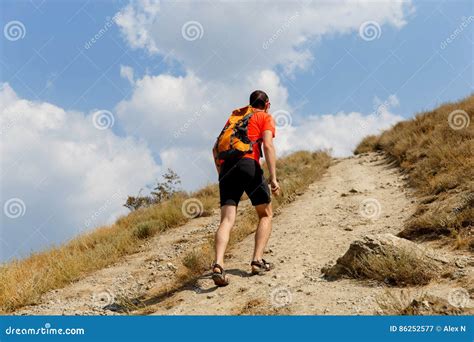 Man Walking Up Steep Mountain Stock Image Image Of Hill Cloudscape