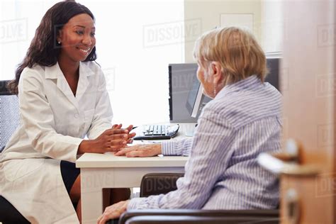 Senior Patient Having Consultation With Doctor In Office Stock Photo