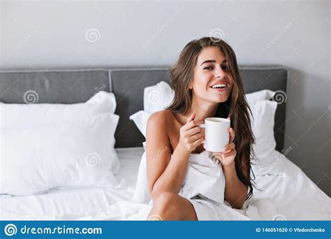 Portrait Pretty Girl With Naughty Shoulders Drinking Coffee On Bed In