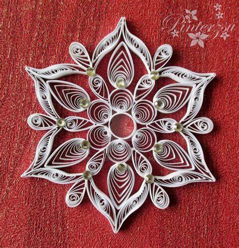 A Paper Snowflake On A Red Background