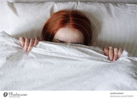 Woman Hiding Face From Sunlight Under Bed Cover A Royalty Free Stock