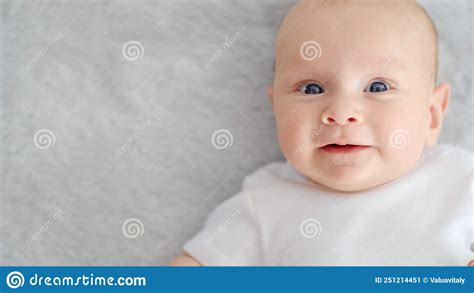 Child`s Face Of A Happy Newborn Baby Looking To Camera Healthy Newborn