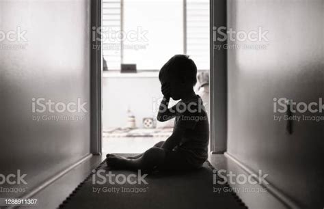Depressed Little Boy Sitting On The Floor Stock Photo Download Image