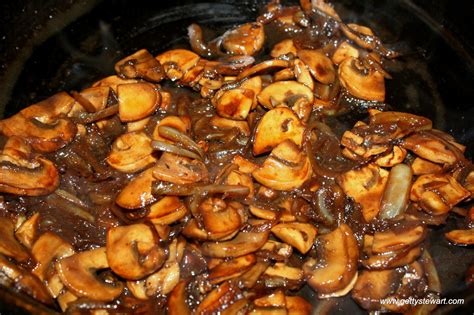 Add sliced white mushrooms, chopped onions, butter and minced garlic to a large cast iron skillet. Getty Stewart Sauteed Mushrooms and Onions