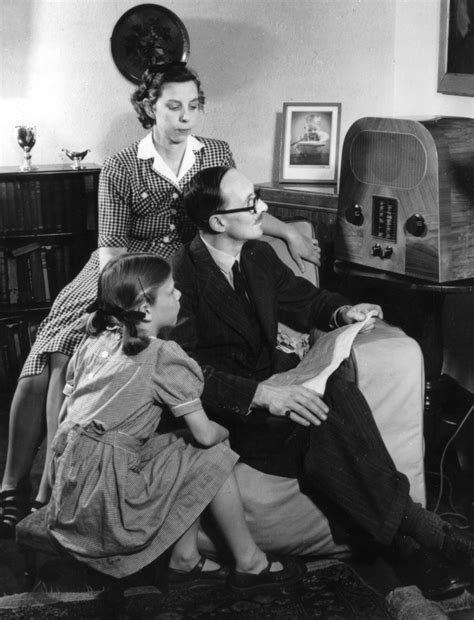 A family grouped around a wireless set listening to BBC radio in 1947