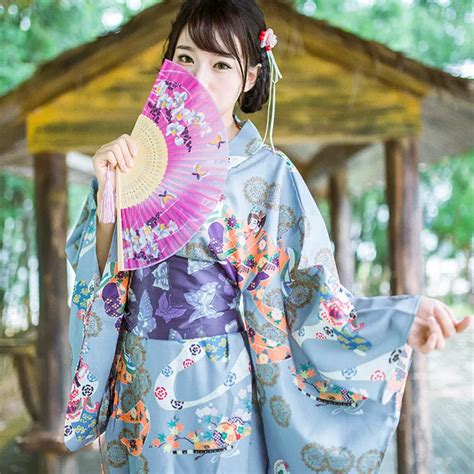 Young Japanese Woman In A Traditional Kimono Against White Background