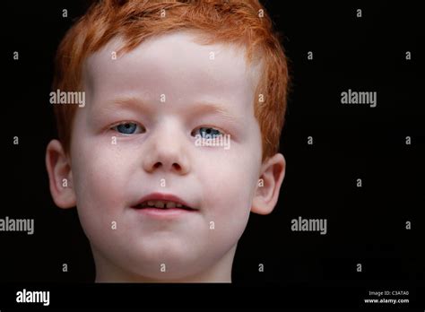 A 7 Year Old Boy Stares Black Background Smiling Stock Photo Alamy