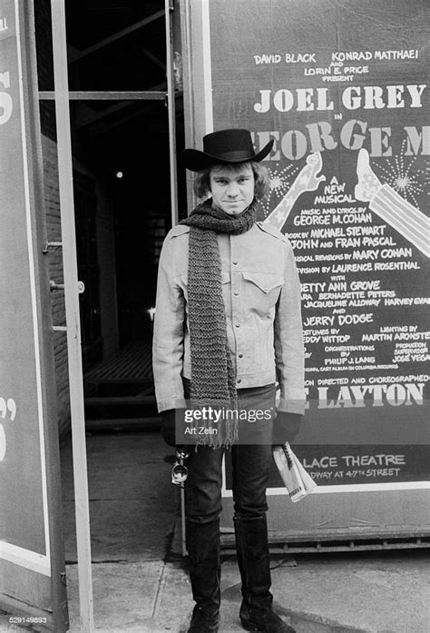 Michael J Pollard Standing In Front Of A Theater Poster For George