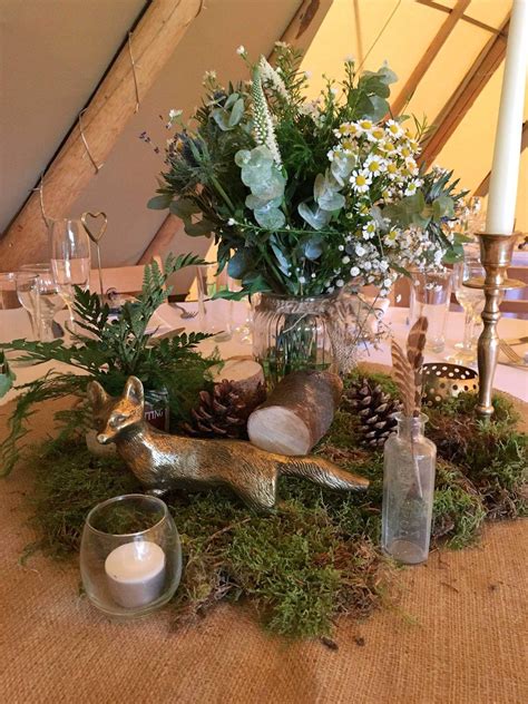 Spring centerpieces add just the right touch to a fun, warm weather meal. Woodland Themed Tipi Styling | Woodland wedding centerpieces