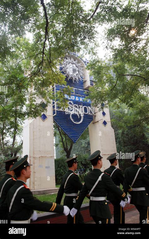 Chinese Paramilitary Policemen Patrol Past The Signboard Of The Passion Club In Beijing China