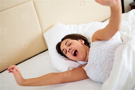 Woman Yawning And Stretching Arms In Bed Stock Photo 182312