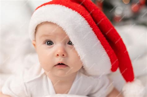 Premium Photo Cute Baby In Santa Hat At Home In Bed The First New
