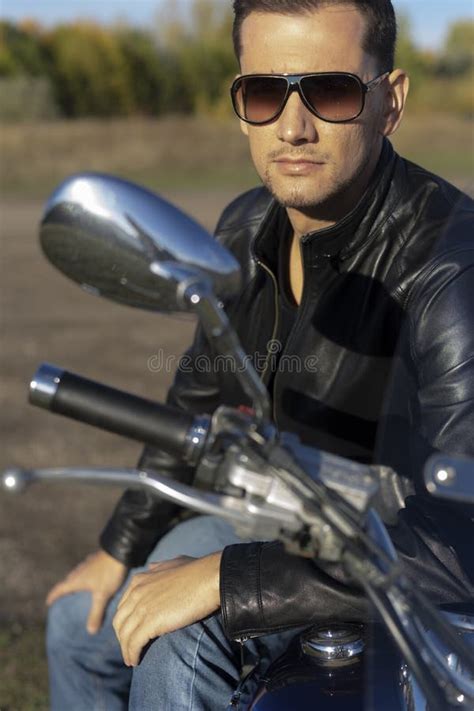Young Man Wearing A Black Leather Jacket Sunglasses And Jeans S Stock