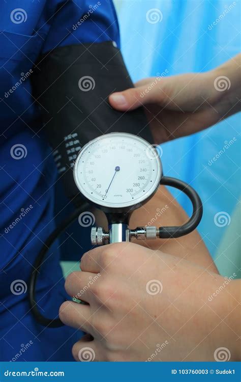 Nurse Measures The Blood Pressure To The Patient In The Emergency Room