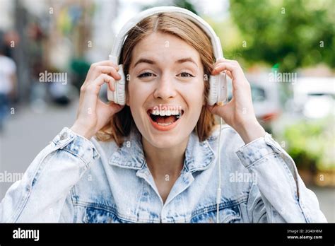 Portrait Of A Cheerful Stylish Young Woman Wearing Denim Jacket