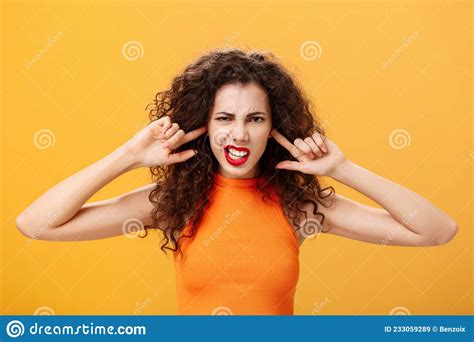 Waist Up Shot Of Irritated Bothered Stylish Woman With Curly Hair And