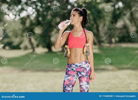 Attractive Fitness Athlete Woman Drinking Water After Workout