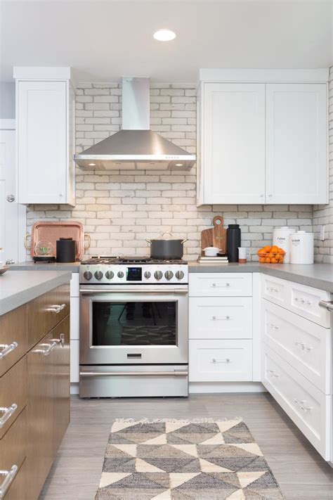 Modern kitchen cabinets paired with a brick accent wall is currently a hot trend that doesn't seem to be slowing down. Modern White Kitchen with White Brick Backsplash | HGTV