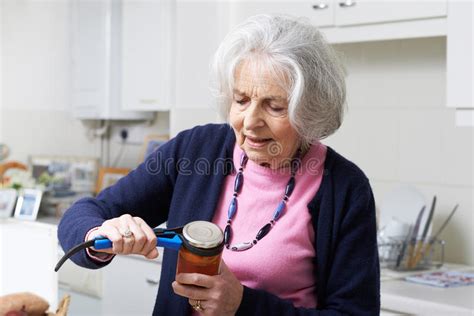 Senior Woman Taking Lid Off Jar With Kitchen Aid Stock Image Image Of