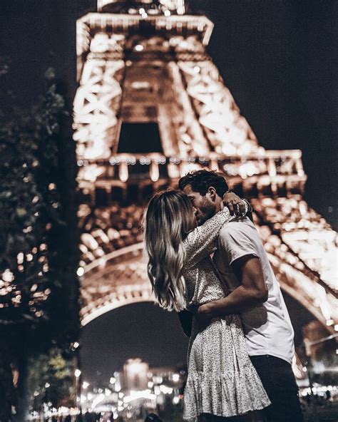 a kiss under the eiffel tower paris mikuta paris couple paris love photo