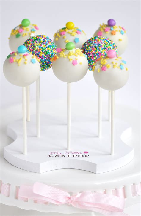 Grease and flour cake pop pan. Fun and festive cake pops displayed on a cake pop stand by ...