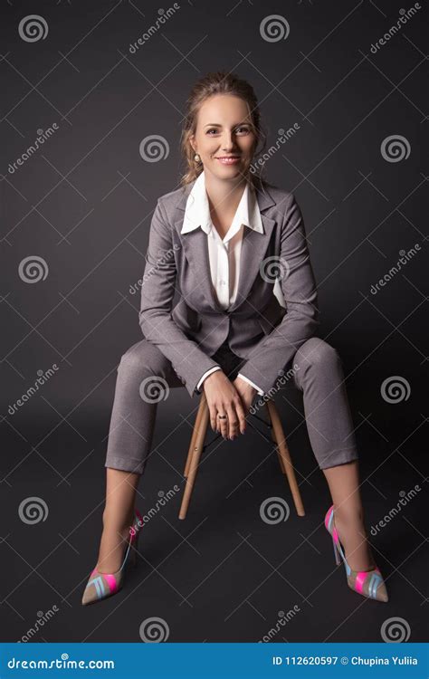 Business Lady In Suit Sits On A Chair On Black Background Stock Image Image Of Corporate