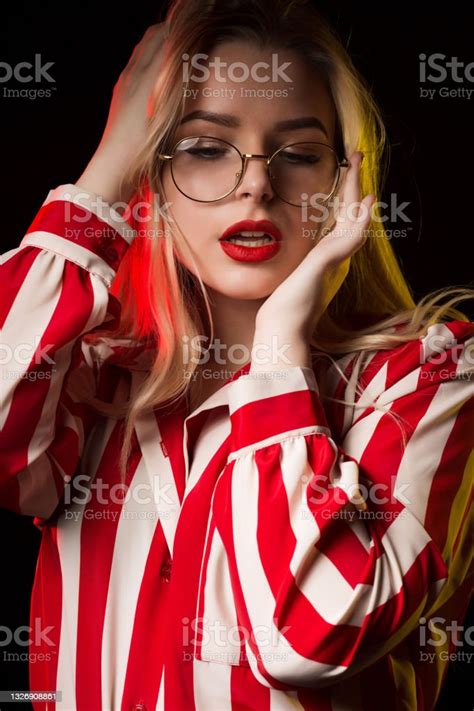 Adorable Blonde Woman In Glasses Posing With Yellow And Red Studio
