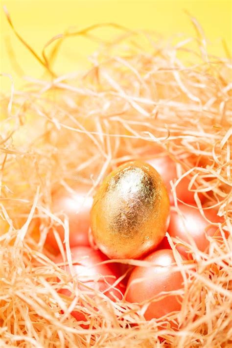 Light Happy Easter Background Golden Colored Eggs In Hay Nest Close Up