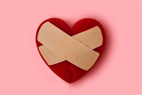 Broken Heart With Wound Plaster Concept Of Love And Care Stock Photo