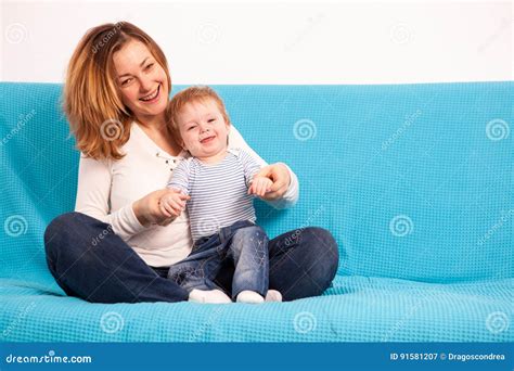 Happy Smiling Mother And Her Son On The Couch Stock Image Image Of