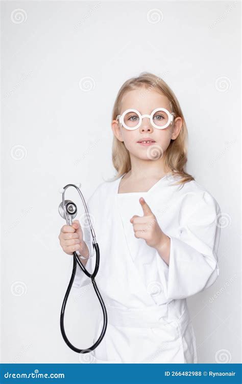 Kid Dressed Up In Doctor Uniform With Toy Eyeglasses Holding