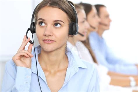 Call Center Operator In Headset While Consulting Client Telemarketing