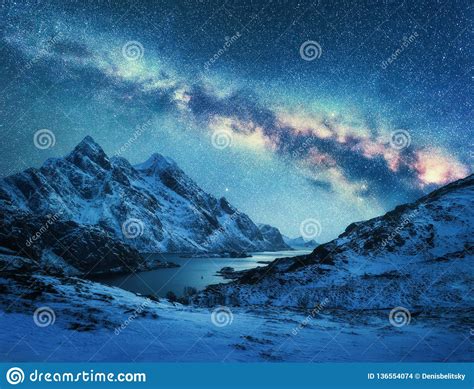 Milky Way Over Snow Covered Mountains And Sea Coast At Night Stock