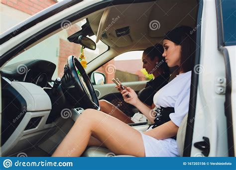 Beautiful Woman Smiling While Sitting On The Passenger Seats In The Car