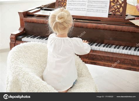 Little Girl Playing Piano Indoors Stock Photo By ©belchonock 175185020