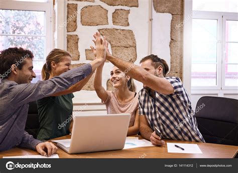 Young Team Giving High Five — Stock Photo © Pablocalvog 141114312