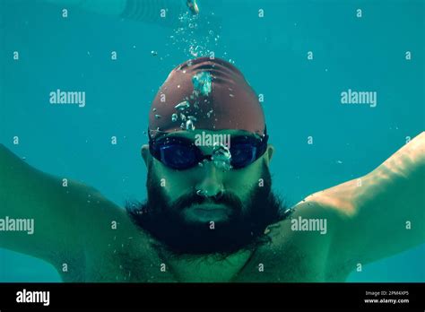 Professional Male Swimmer Practising In Swimming Pool Underwater Shot