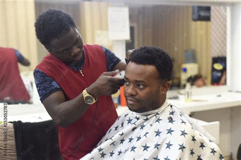 Black Man In The African Barbershop Cute Black Man Makes A Haircut In