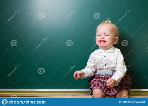 Baby Girl Crying Near A School Blackboard Learning Difficulties Stock