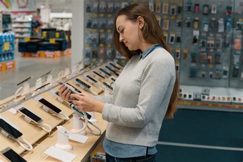 Customer Choosing Smartphone In The Mobile Phone Shop Stock Photo