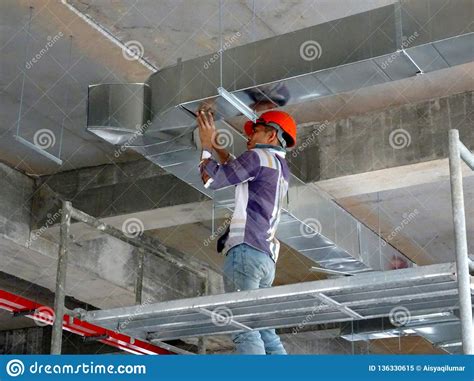Construction Workers Installing Air Conditioning Duct Editorial Image ...
