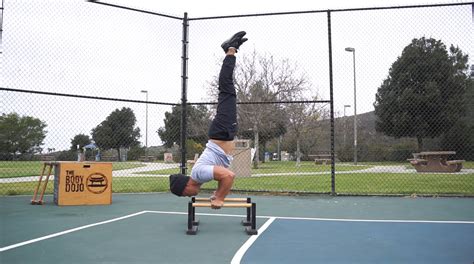 L Sit To Handstand To Handstand Push Ups On Parallettes The Body Dojo