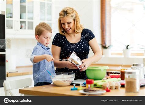 Child Helping Mother In Kitchen — Stock Photo © Nd3000 166639650